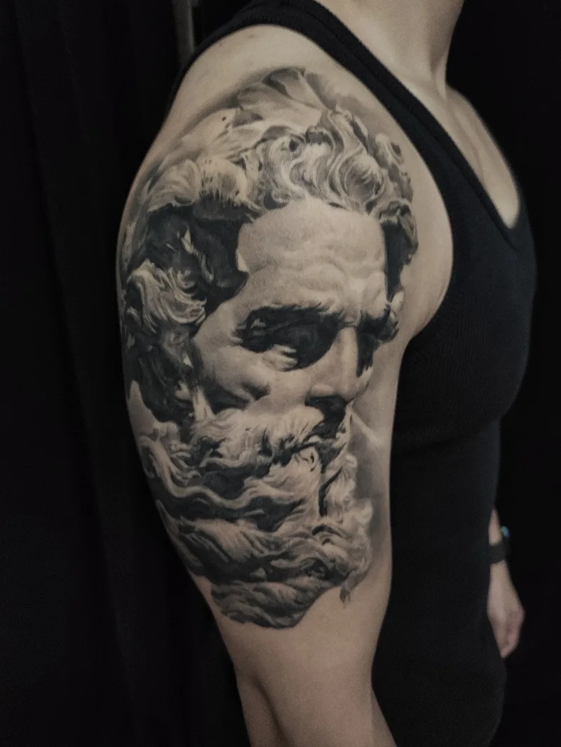 Sculpture face arm tattoo done by Shang Qi Liu